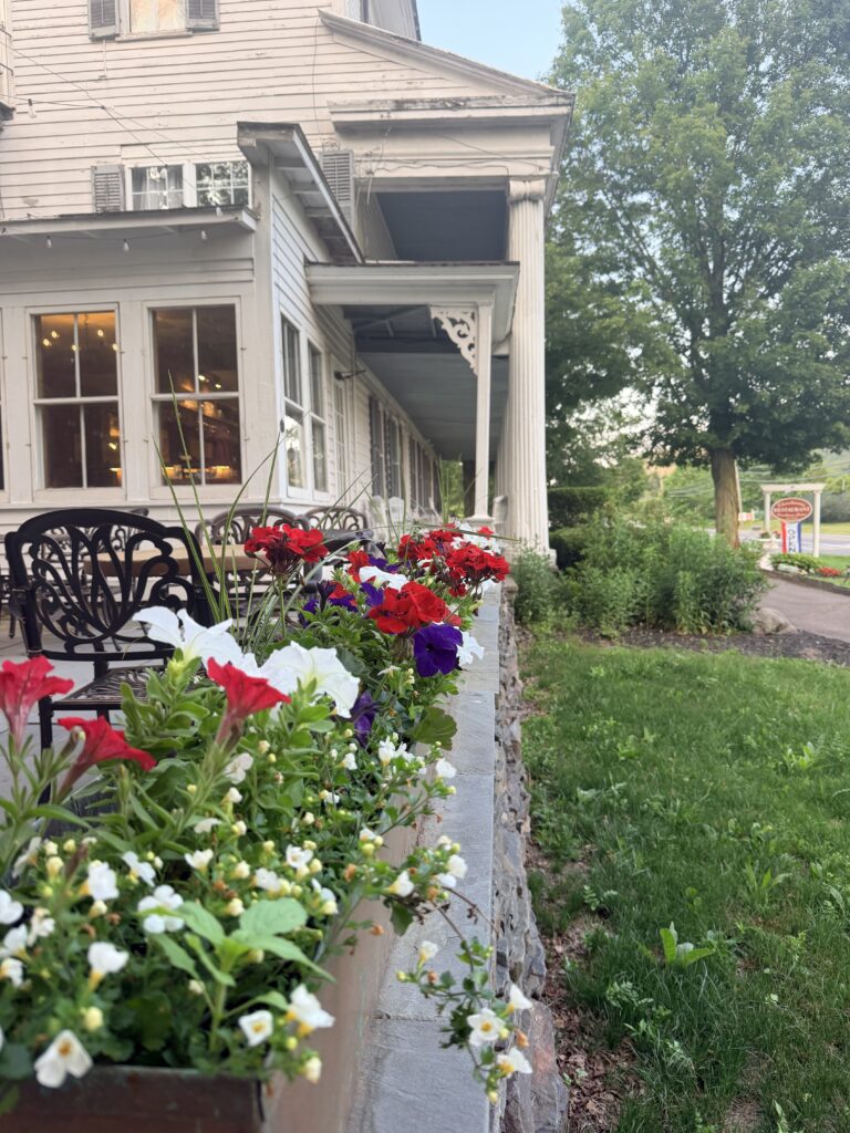 Side view of colonial Inn with flower boxes in foreground